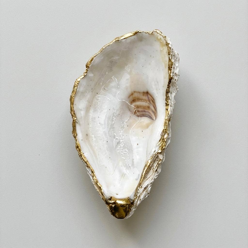 Neutral tone oyster shell trinket dish with gold rim finish