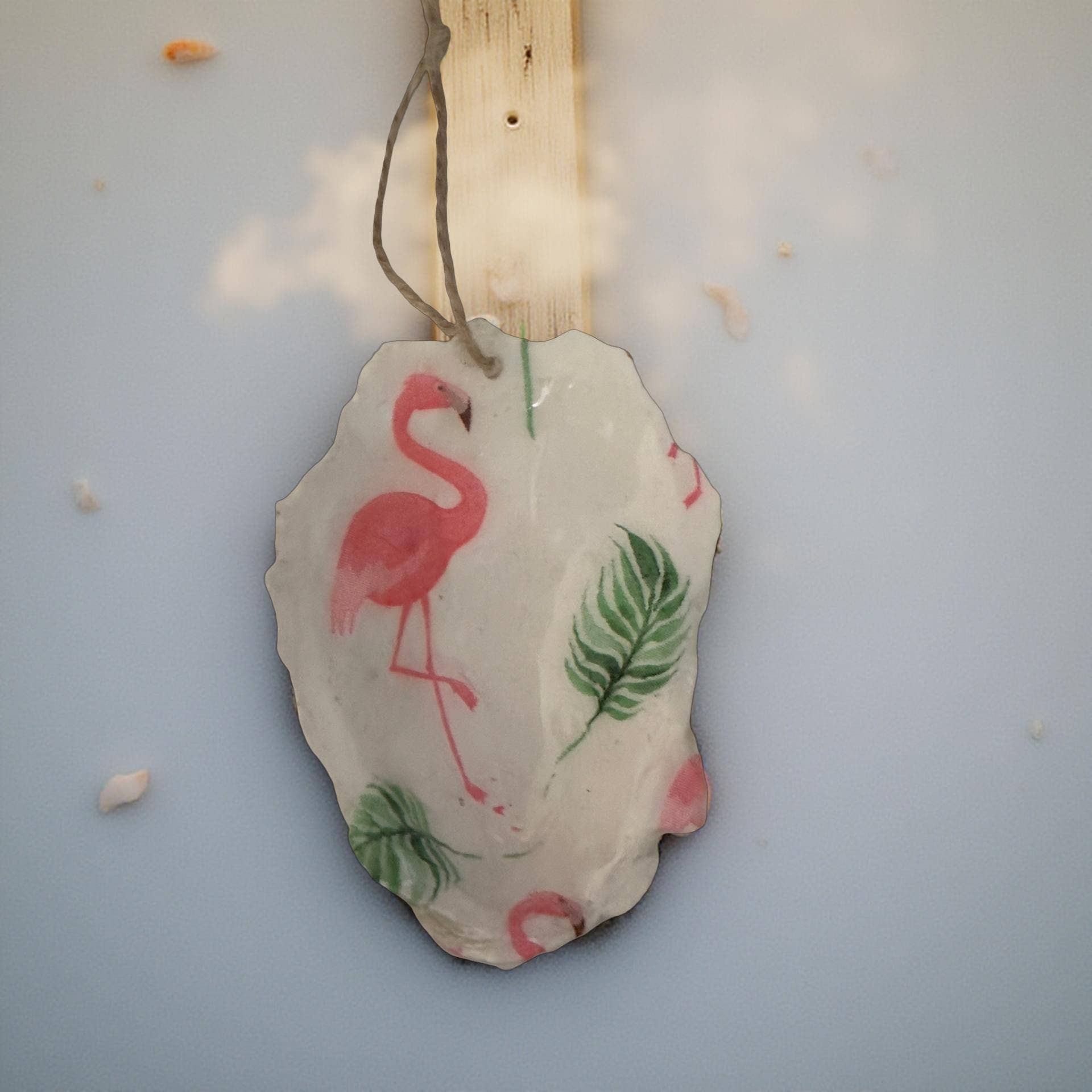 Flamingo and palm tree motif oyster shell holiday ornament with gold finish