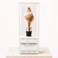 Striped conch shell wine stopper with gold base finish