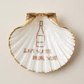 Humorous wine-themed scallop shell dish with gold accents
