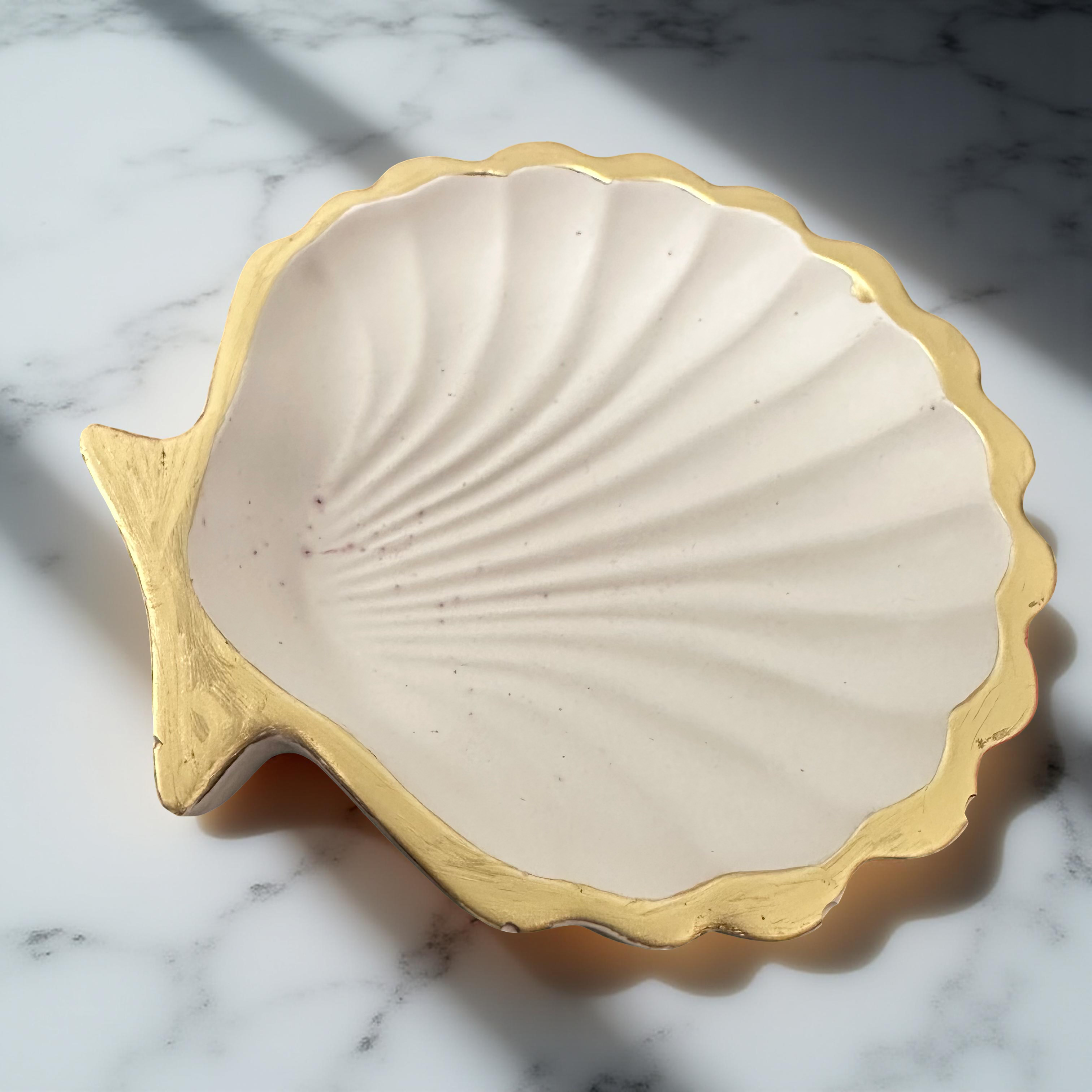 Scallop shell serving dish in neutral tones with gold finish
